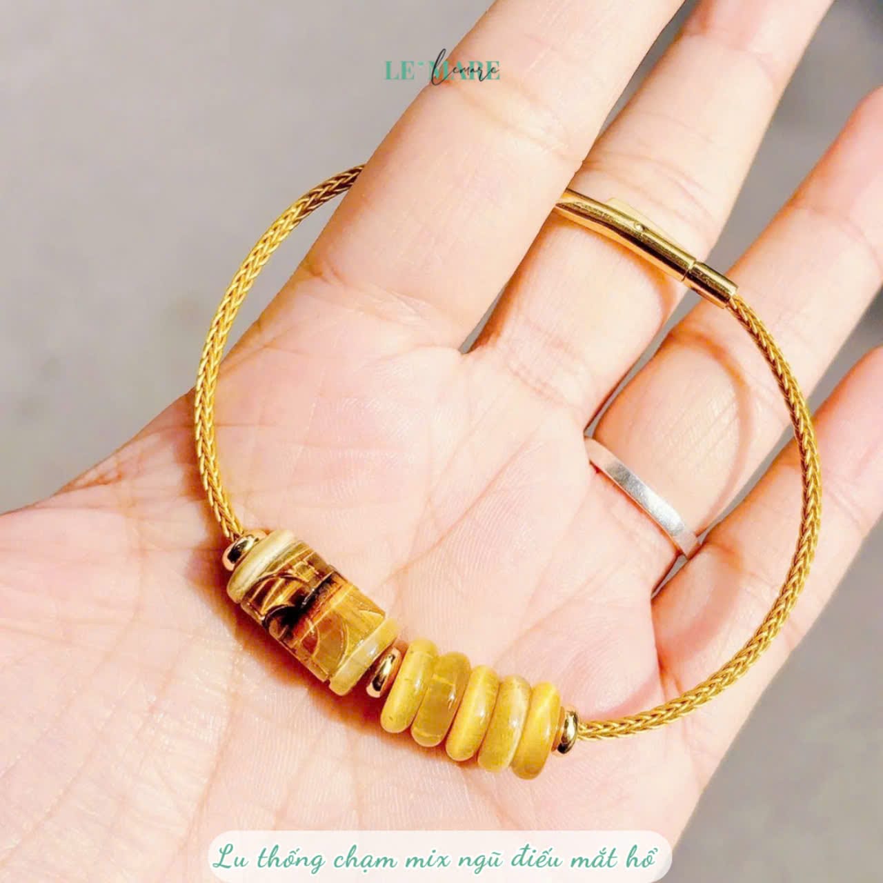 Vòng tay dây cáp lu thống chạm khắc mix ngũ điếu mắt hổ vàng tâm Le'Mare Jewelry – Gợi ý món quà độc đáo và ý nghĩa dành tặng người phụ nữ trân quý trong các dịp kỷ niệm, ngày lễ 20/10, 8/3... Vòng tay dây cáp lu thống chạm khắc mix ngũ điếu mắt hổ vàng tâm Le'Mare Jewelry – Gợi ý món quà độc đáo và ý nghĩa dành tặng người phụ nữ trân quý trong các dịp kỷ niệm, ngày lễ 20/10, 8/3... Le'mare Jewelry LMJ