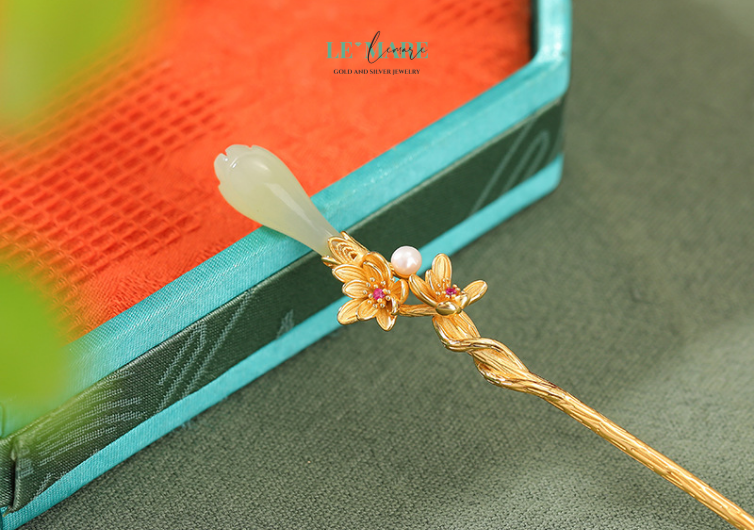 Trâm cài tóc ngọc bích Hoàng Diệp – Đóa hoa vàng rực rỡ trên mái tóc người thương BNTC03 Hình ảnh hoa vàng đang nở trên thân trâm không chỉ là một điểm nhấn thẩm mỹ, mà còn là biểu tượng của sự thăng hoa, khởi đầu tốt đẹp và vẻ đẹp viên mãn. Sắc vàng tượng trưng cho ánh sáng, cho năng lượng dồi dào và niềm vui sống, hòa quyện cùng đường nét uốn lượn mềm mại của trâm bạc, khiến tổng thể trở nên sống động mà vẫn giữ được sự thanh lịch tinh tế.